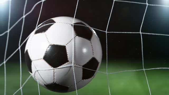 Super Slow Motion Shot of Football Ball Hitting Soccer Goal Net