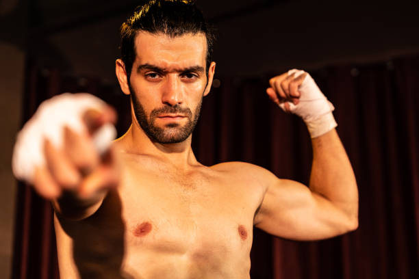 istock Caucasian boxer punch his bare fist and wrap posing. Impetus 2032440236