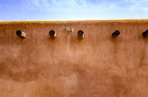 Adobe wall in New Mexico reflects the warm afternoon sunlight