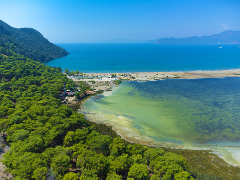 Loggerhead turtle spawning site Iztuzu Beach. It is known for its blue crab and golden sands. Next to Dalyan delta. Drone view from above valley of beach and mountains. Tourist place in Turzia.