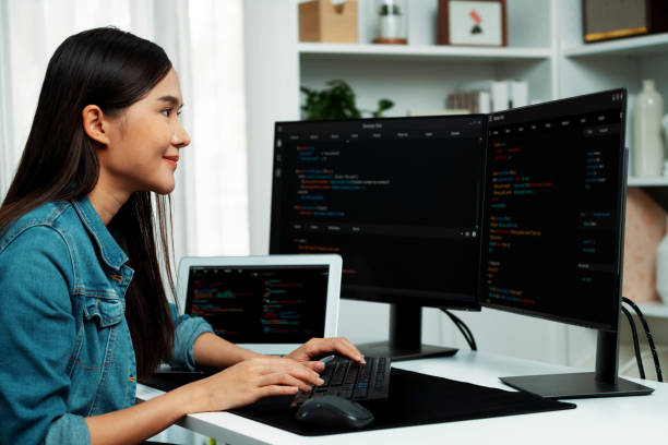 istock Young Asian in IT creating with typing online information on pc. Stratagem. 2032451684