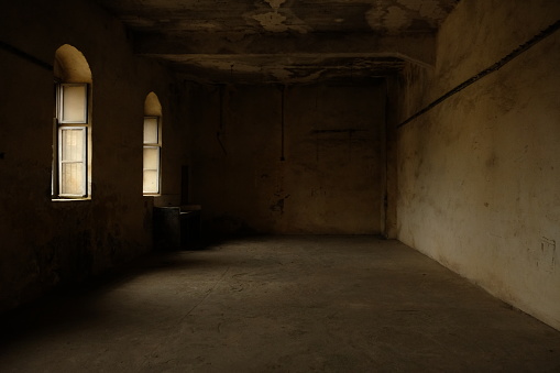 Abandoned castle, domestic room with fireplace and large broken windows