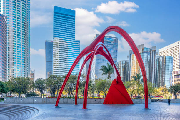 Entrance Courtyard of Bank of America Plaza and view of Downtown Los Angeles with Four Arches red metallic sculpture designed by American artist Alexander Calder in 1974.