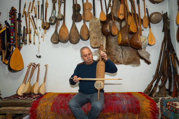 der mann spielt ein asiatisches musikinstrument iklg oder iklik. - turkish ethnicity white black contemporary stock-fotos und bilder