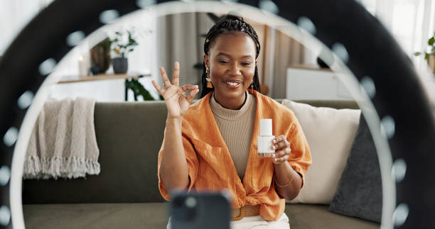 istock Video, content creator and black woman doing skincare for tutorial on social media or the internet. Dermatology, happy and African female influencer filming or live streaming face routine at home. 2032482502