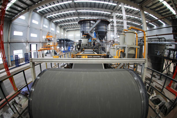 istock workers operate the distributor on the calcium silicate board production line, North China 2032485860