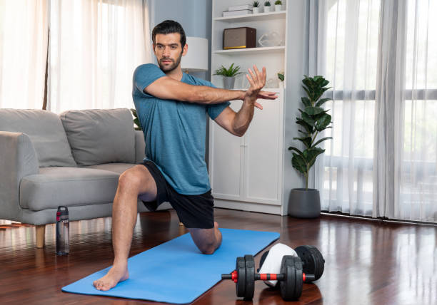 istock Athletic and sporty man doing warmup at gaiety home exercise. 2032491448
