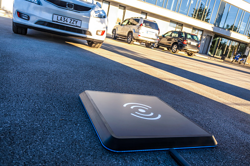 Close-up of wireless charger on road.
