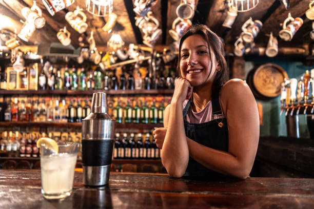 istock Portrait of a bartender leaning on bar counter 2032508415