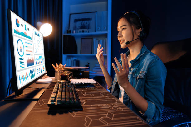 istock Asian influencer wearing headsets on pc business graph screen. Stratagem. 2032517806