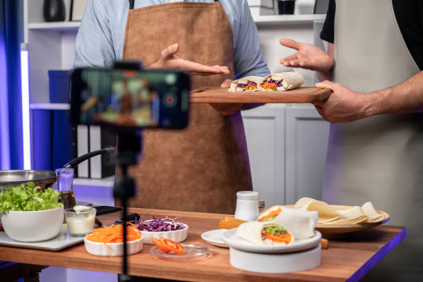 istock Cropped view of chef influencers presenting fresh salad roll. Sellable. 2032529594