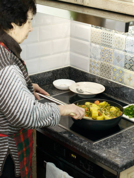 istock Elderly Woman Cooking Vegetables 2032536606