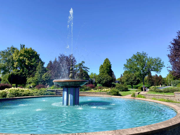 istock fountain in a park. Beautiful background 2032542629