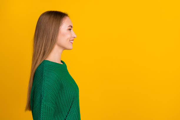 istock Profile side photo of friendly charming young woman wear green pullover looking empty space cheerful isolated on yellow color background 2032543203