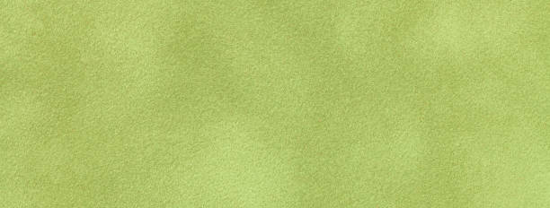 istock Texture of light green velvet matte background, macro. Suede olive fabric with pattern. 2032560495