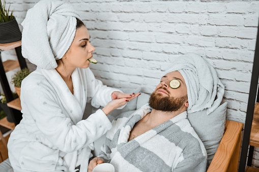 Relaxed Male Taking A Nap During Girlfriend's Cucumber Slices Skincare Routine