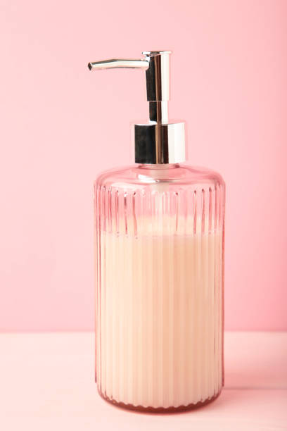 istock Soap dispenser on pink background. Vertical photo 2032565347