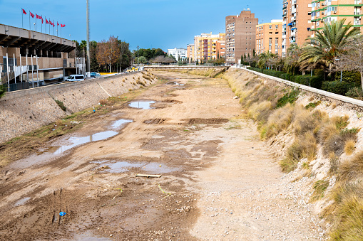 Cartagena, Murcia - Spain - 01-16-2024: A dry canal within Cartagena featuring sloped, reinforced sidewalls for drainage and urban infrastructure