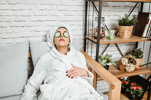 Female Falling Asleep With Cucumber Slices On Eyes While Relaxing After Bath