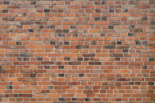 Brickwall with red, brown and black bricks