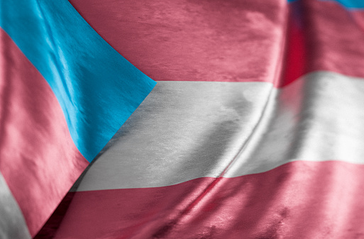 Full frame background of an LGBTQ+ pride flag moving in the wind. Close-up of the transgender pride flag.