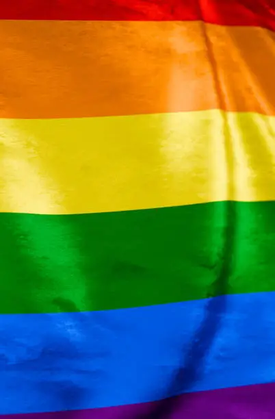 Photo of Rainbow pride flag background waving in the wind