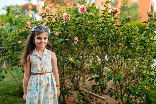 Portrait of a beautiful little girl in the garden in Hurghada, Egypt.