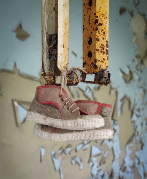 istock Child Shoes with Red Stripe Hanging 2032579667