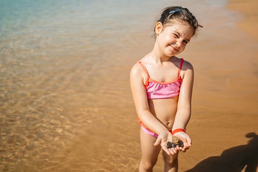 Portrait of a beautiful little girl on the beach in Hurghada in Egypt.