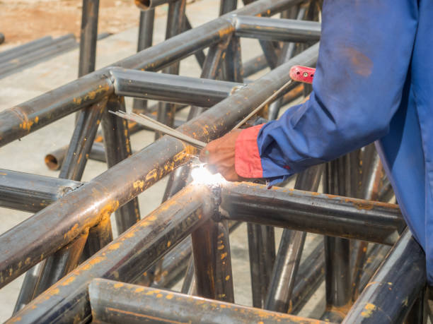 istock A welder is using welding rods to weld trusses by the arc technique. 2032580064