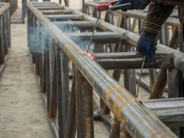 istock Trusses for factory construction is under the process of welding. 2032580413