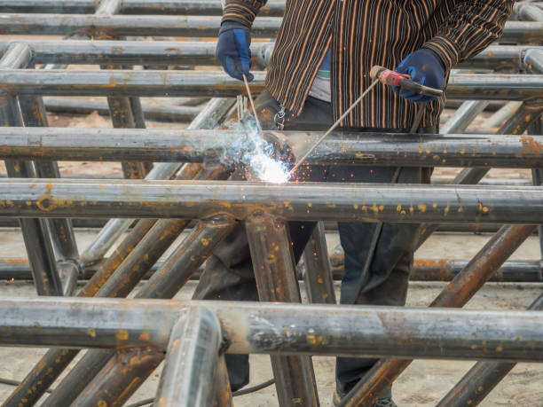 istock A worker is using welding rods to weld trusses by the arc technique. 2032580416