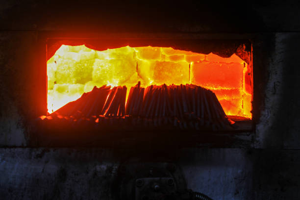Hot steel slab passes along a rolling machine at a steel plant.