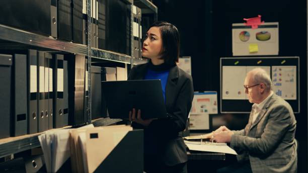 istock Detective evaluating old archived folders to organize all cases based on crimes 2032626662