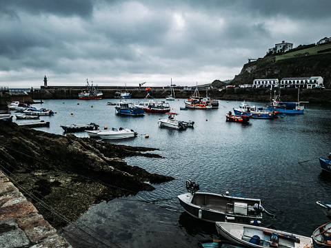 The Numerous boats sail in the harbor under overcast skies, Mevagissey, UK