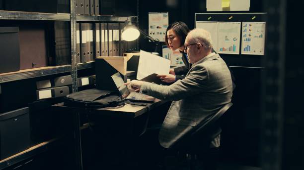 istock Detective team examines archived files for crucial case evidence 2032639839