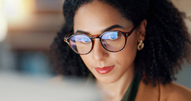 istock Happy woman at desk with computer, glasses and reflection, reading email or article at digital agency. Internet, research and thinking, girl at tech startup with online report or networking project. 2032640391