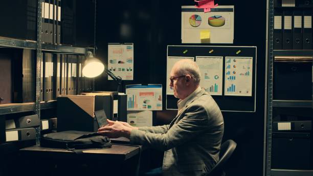 istock Senior investigator studying archive folders for case similarities 2032649813