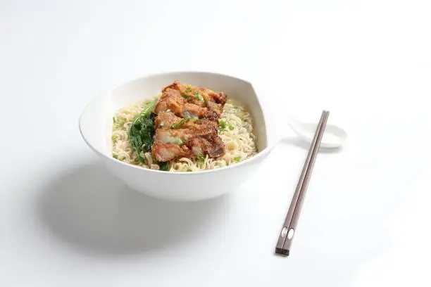 cook Japanese instant noodle mee soup with chicken chop cutlet and vegetables on bowl chopstick on white vintage newspaper background asian chef halal food restaurant banquet menu