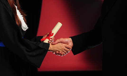 Students receiving graduation diploma