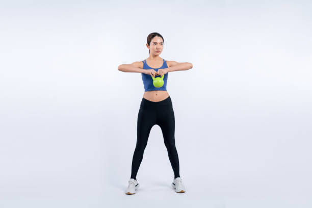 istock Vigorous energetic woman doing yoga with kettlebell weight exercise. 2032686030