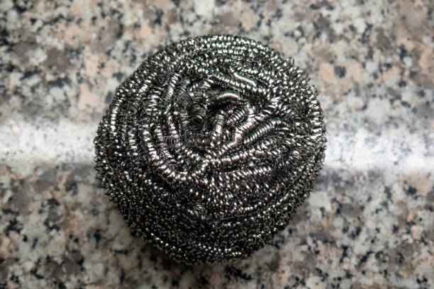 Kitchen wire cleaning or scrubbing sponge, on granite counter top.