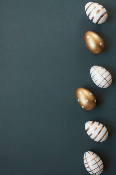 istock Happy Easter concept with elegant Easter eggs decorated with gold on dark gray blue background with copy space 2032710915