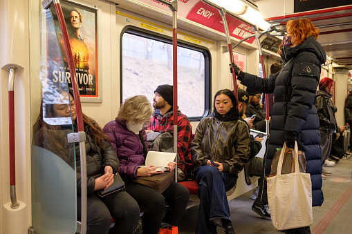 This is a TTC Subway Train in Toronto and Canadians from Different Races and Cultures are Onboard.