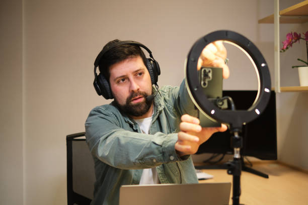 istock Casual man arranging set up to record vlogging at home 2032717299