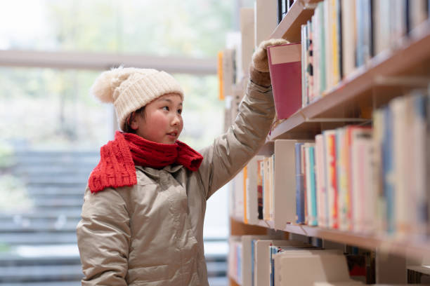 istock girl choosing a book 2032725774
