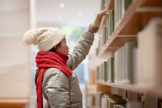 istock girl choosing a book 2032725776