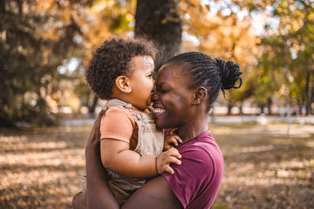 istock Mother's Embrace: Joyful Moments in the Park 2032786747