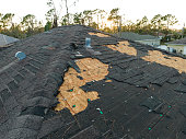Natural disaster and its consequences. Hurricane Ian destroyed house roof in Florida residential area