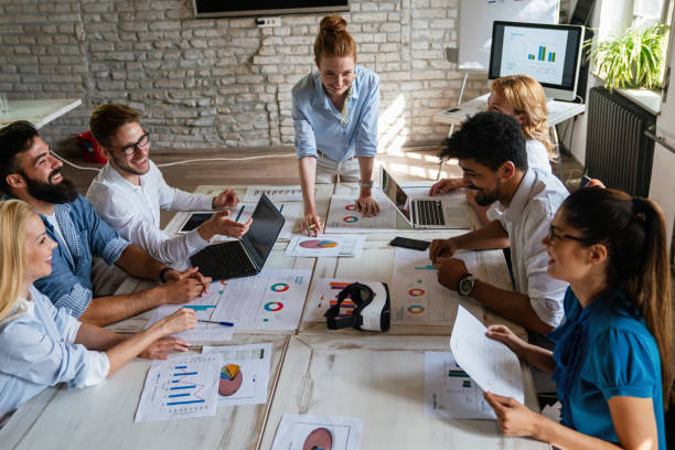 istock Group of multiethnic business people brainstorming, analyzing financial reports in office 2032802932
